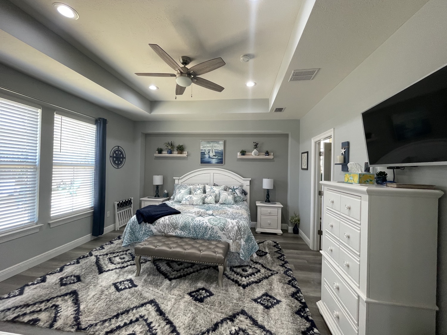 Master bedroom with king bed and coastal decor